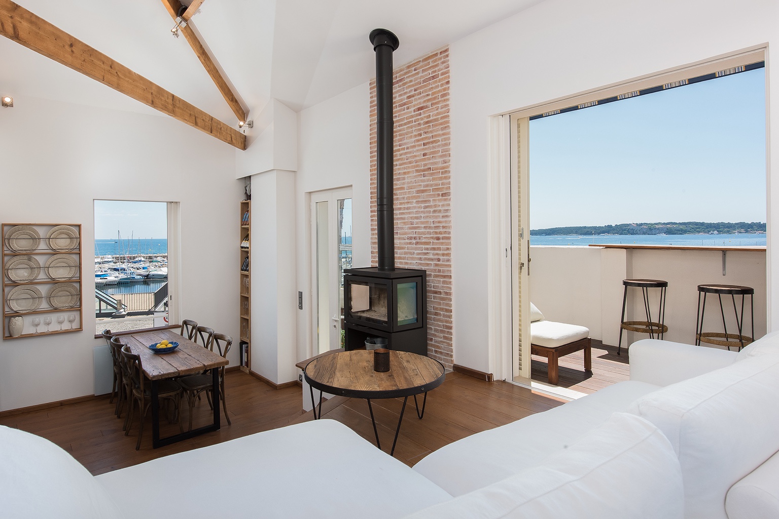 Living room with stove and open doors to terrace